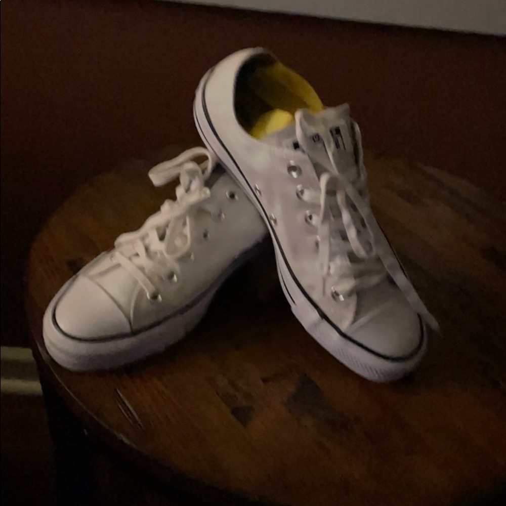 White Converse low top sneakers.